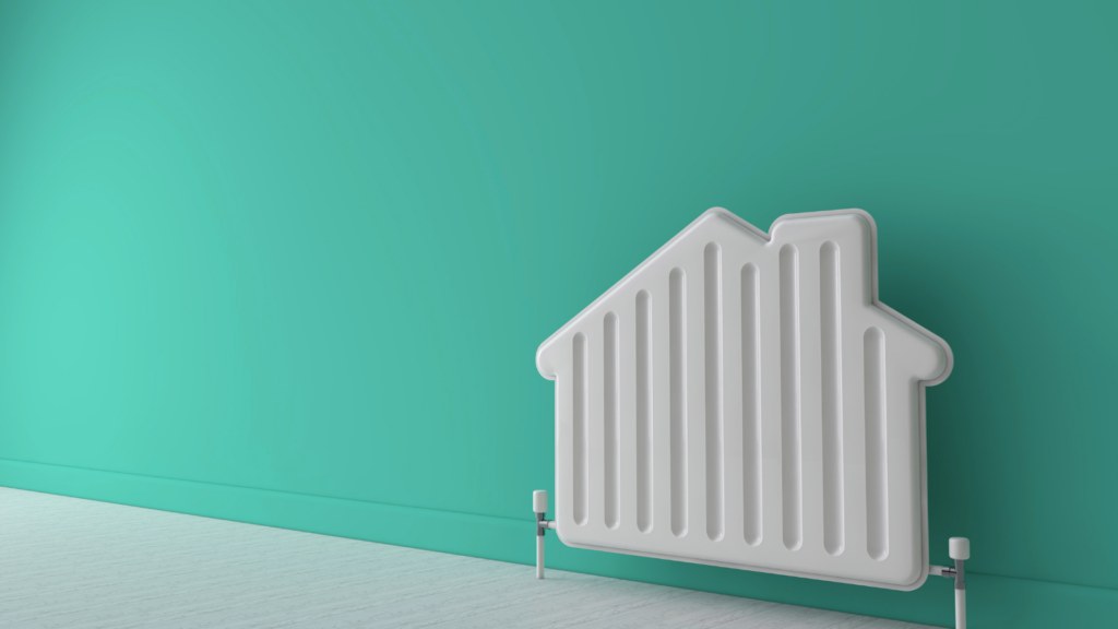 A white house shaped radiator against a light blue wall