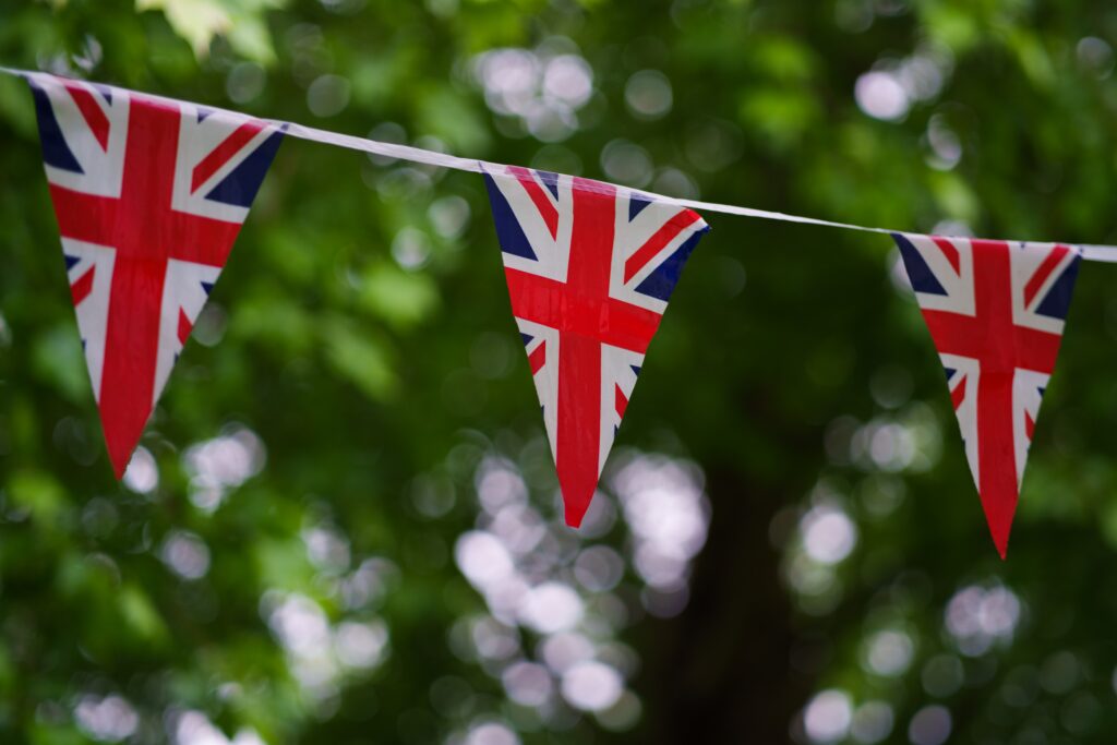 Union Jack bunting hung up in front of trees outside